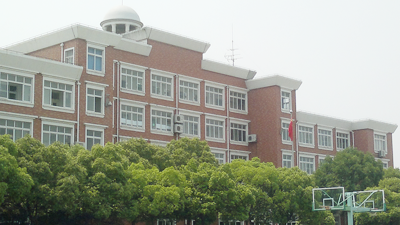 写真1 インタビューをした上海市内にある私立中・高等学校の本校舎。右手には国旗が挙げられています